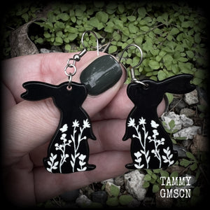 Featuring a black rabbit silhouette looking skyward with white floral sprig, these earrings are nice and lightweight, weighing only a few grams each and measure approx 6 from tip to tip. This pair has made on stainless steel french hooks.