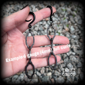 These gorgeous gothic ear hangers feature beautiful rustic antique bronze florentine style chain links, measuring approx 11cms from tip to tip, and weighing approx 10 grams each.

This pair has been made on 6 gauge (4mm) surgical steel full curls, to be worn in stretched lobes.