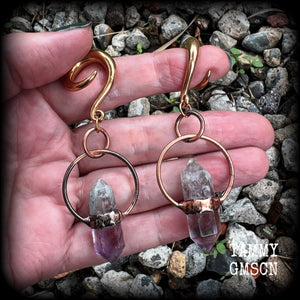 Featuring a pair of beatifully rustic purple fluorite points in an antique copper setting, these gauged earrings measure just over 8cms from tip to tip, and weigh approx 13 grams each.
This pair has been made on 2 gauge (6mm) surgical steel full curl hooks, suitable for stretched lobes.