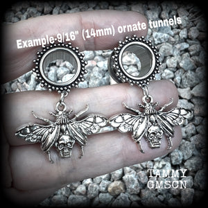 These gorgeous tunnel dangles feature antique silver beetles with wings open revealing a skull underneath.
These are nice and light weight, weighing in at 10 grams each and measure just over 4.5 cms from tip to tip.

This pair have been made with 9/16” gauge (14mm) surgical steel screw fit ornate tunnels.