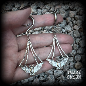 Featuring gorgeous light weight gothic silver bat charms, these spooky cute gauged earrings weigh in at 7 grams a piece, and measure just over 7cms from tip to tip.

This pair has been made on 6 gauge (4mm) surgical steel full curl hooks, to be worn in stretched lobes.
