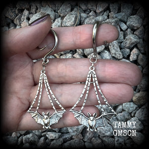 Featuring gorgeous light weight gothic silver bat charms, these spooky cute gauged earrings weigh in at 7 grams a piece, and measure just over 7cms from tip to tip.

This pair has been made on 6 gauge (4mm) surgical steel full curl hooks, to be worn in stretched lobes.