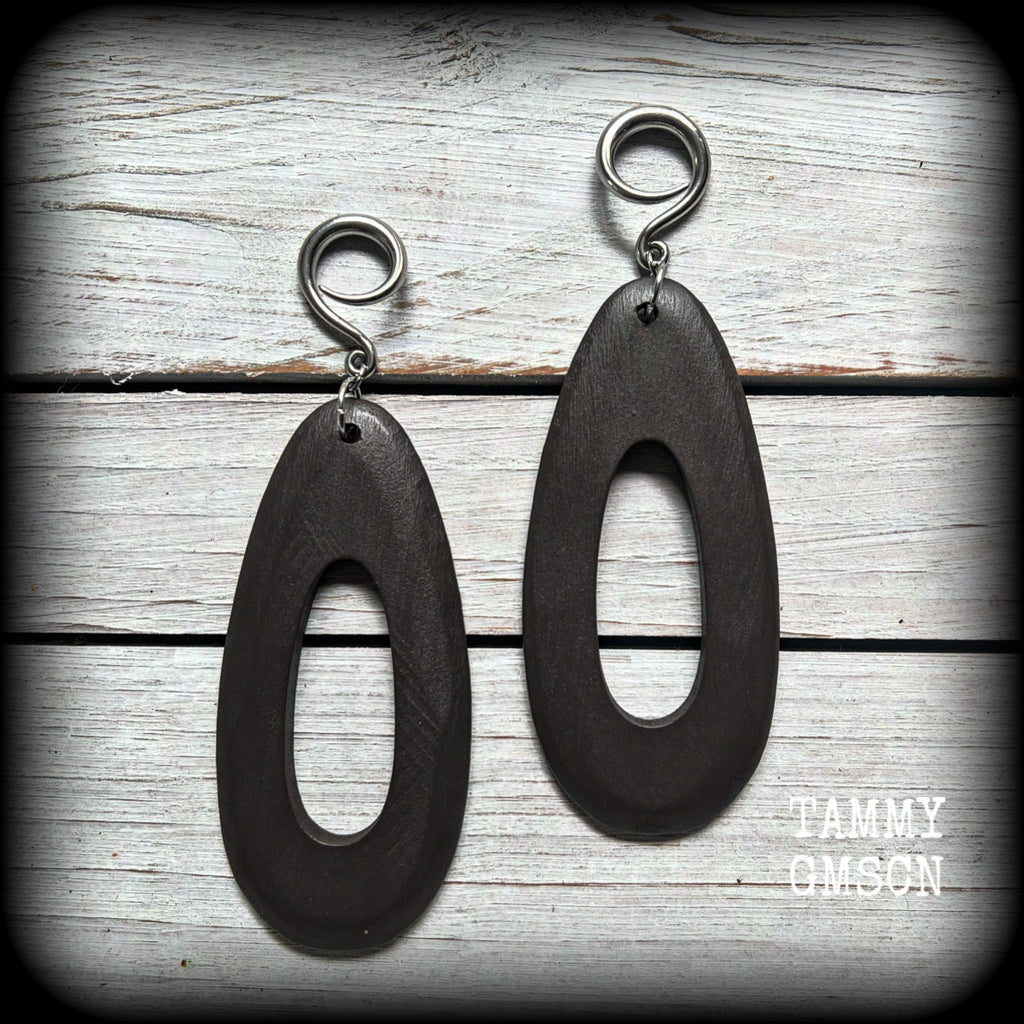 These beautiful carved wood teardop gauged earrings are night and lightweight, weighing in at only 9 grams a piece, and lively and dangly, measuring just on 12cms from tip to tip.
This pair has been made on 6 gauge (4mm) surgical steel full curl hooks, suitable for stretched lobes.