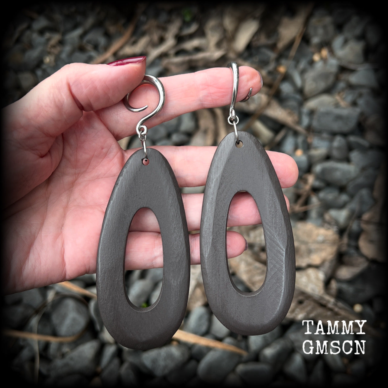 These beautiful carved wood teardop gauged earrings are night and lightweight, weighing in at only 9 grams a piece, and lively and dangly, measuring just on 12cms from tip to tip.
This pair has been made on 6 gauge (4mm) surgical steel full curl hooks, suitable for stretched lobes.