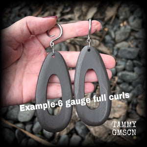 These beautiful carved wood teardop gauged earrings are night and lightweight, weighing in at only 9 grams a piece, and lively and dangly, measuring just on 12cms from tip to tip.
This pair has been made on 6 gauge (4mm) surgical steel full curl hooks, suitable for stretched lobes.