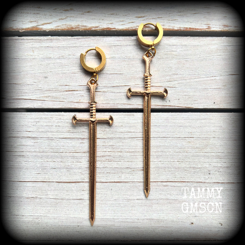 These awesome dangly antique gold sword earrings are nice and lightweight at 7 grams each, and measure in at just under 9cms from tip to tip.
This pair have been made on stainless steel huggie ear cuffs, suitable for pierced ears.