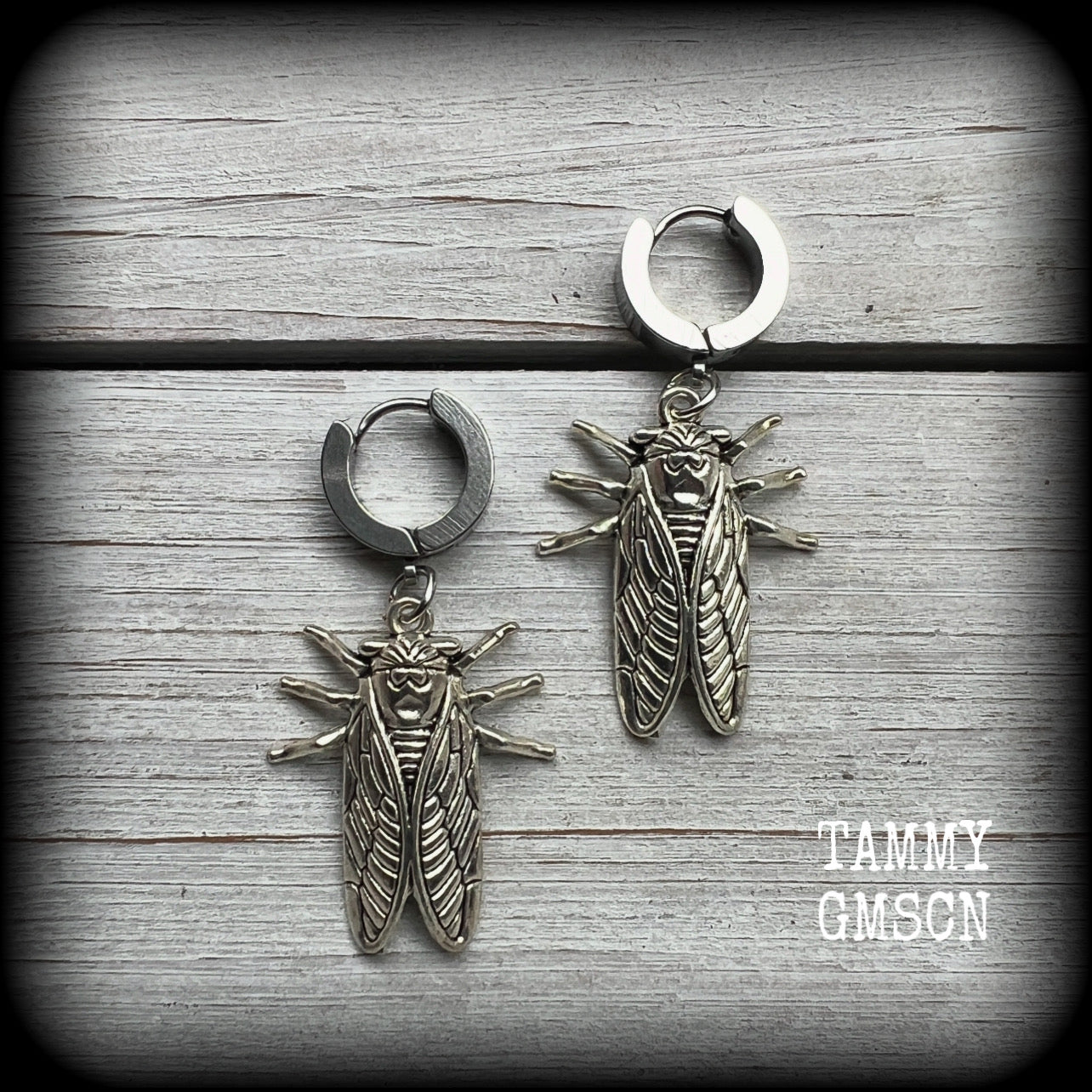 These awesome antique silver cicada earrings are nice and lightweight at 3 grams each, and measure in at approx 4.5cms from tip to tip.
This pair have been made on stainless steel huggie ear cuffs, suitable for pierced ears.