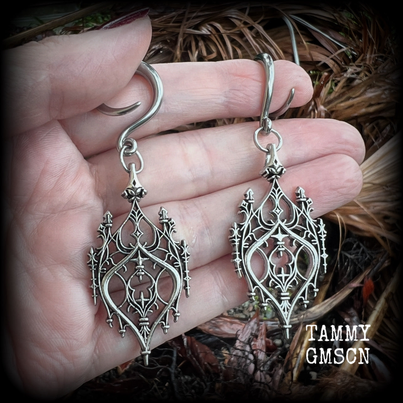 These gorgeous gothic ear hangers feature a beautiful antique silver ornate gothic cathedral chandelier, measuring just on 8cms from tip to tip, and weighing approx 10 grams each. This pair has been made on 6 gauge (4mm) surgical steel full curls.