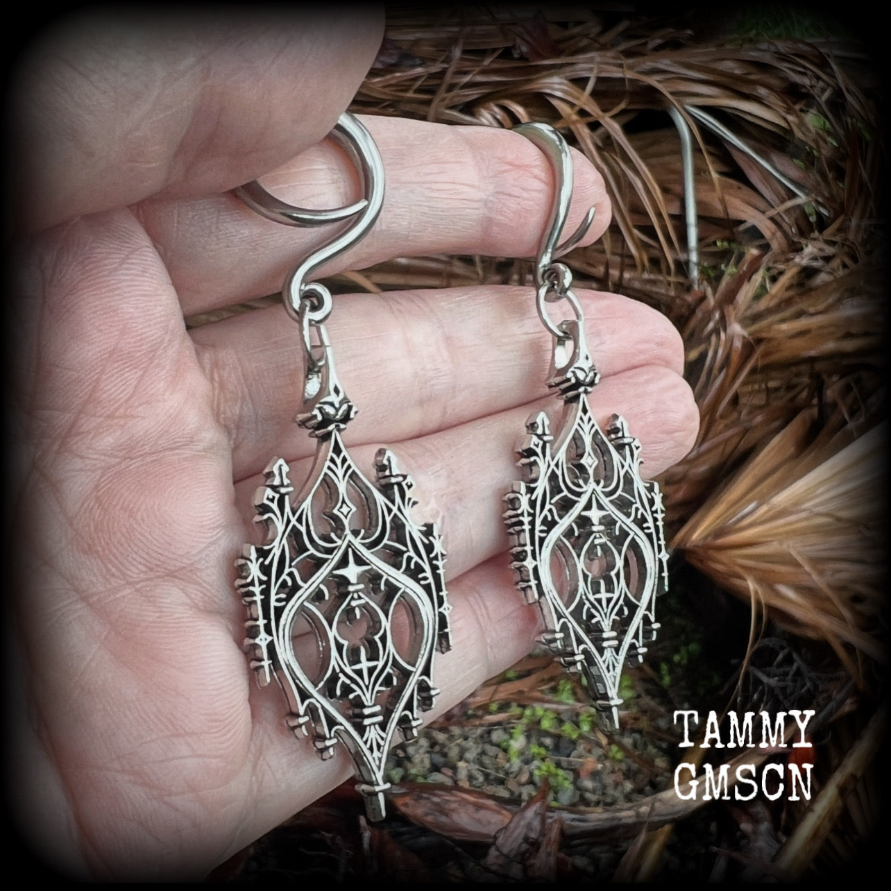 These gorgeous gothic ear hangers feature a beautiful antique silver ornate gothic cathedral chandelier, measuring just on 8cms from tip to tip, and weighing approx 10 grams each. This pair has been made on 6 gauge (4mm) surgical steel full curls.