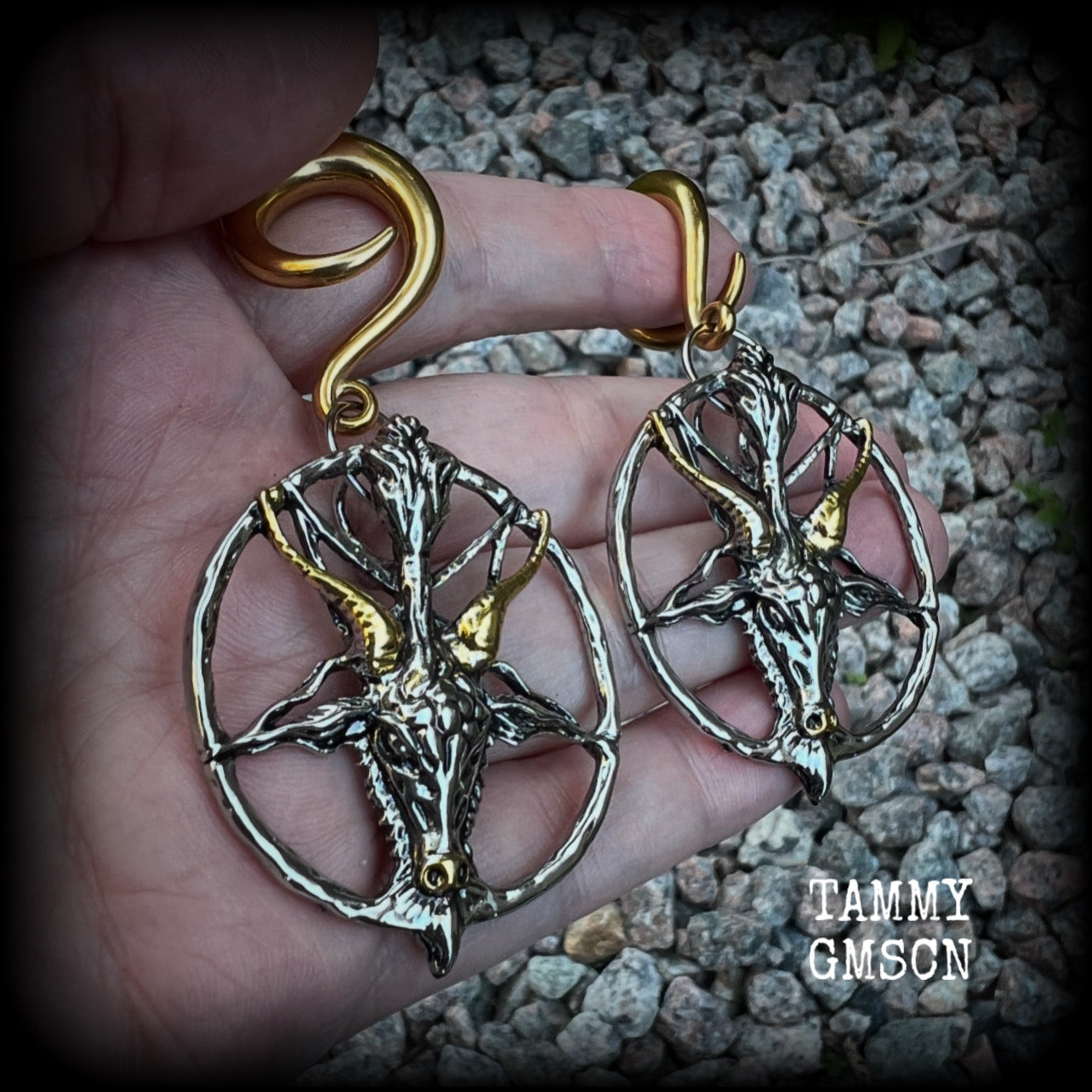 These gorgeous antique silver and gold Baphomet gauged earrings and are nice and dangly and nice and big, measuring 8cms from tip to tip, but not too heavy at only 16 grams each.

This pair has been made on 2 gauge (6mm) surgical steel full curl hooks, to be worn in stretched lobes..