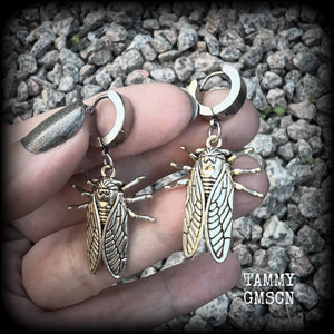 These awesome antique silver cicada earrings are nice and lightweight at 3 grams each, and measure in at approx 4.5cms from tip to tip. This pair have been made on stainless steel huggie ear cuffs, suitable for pierced ears.