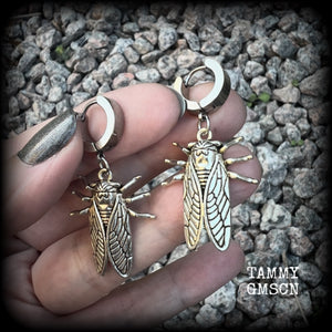 These awesome antique silver cicada earrings are nice and lightweight at 3 grams each, and measure in at approx 4.5cms from tip to tip. This pair have been made on stainless steel huggie ear cuffs, suitable for pierced ears.