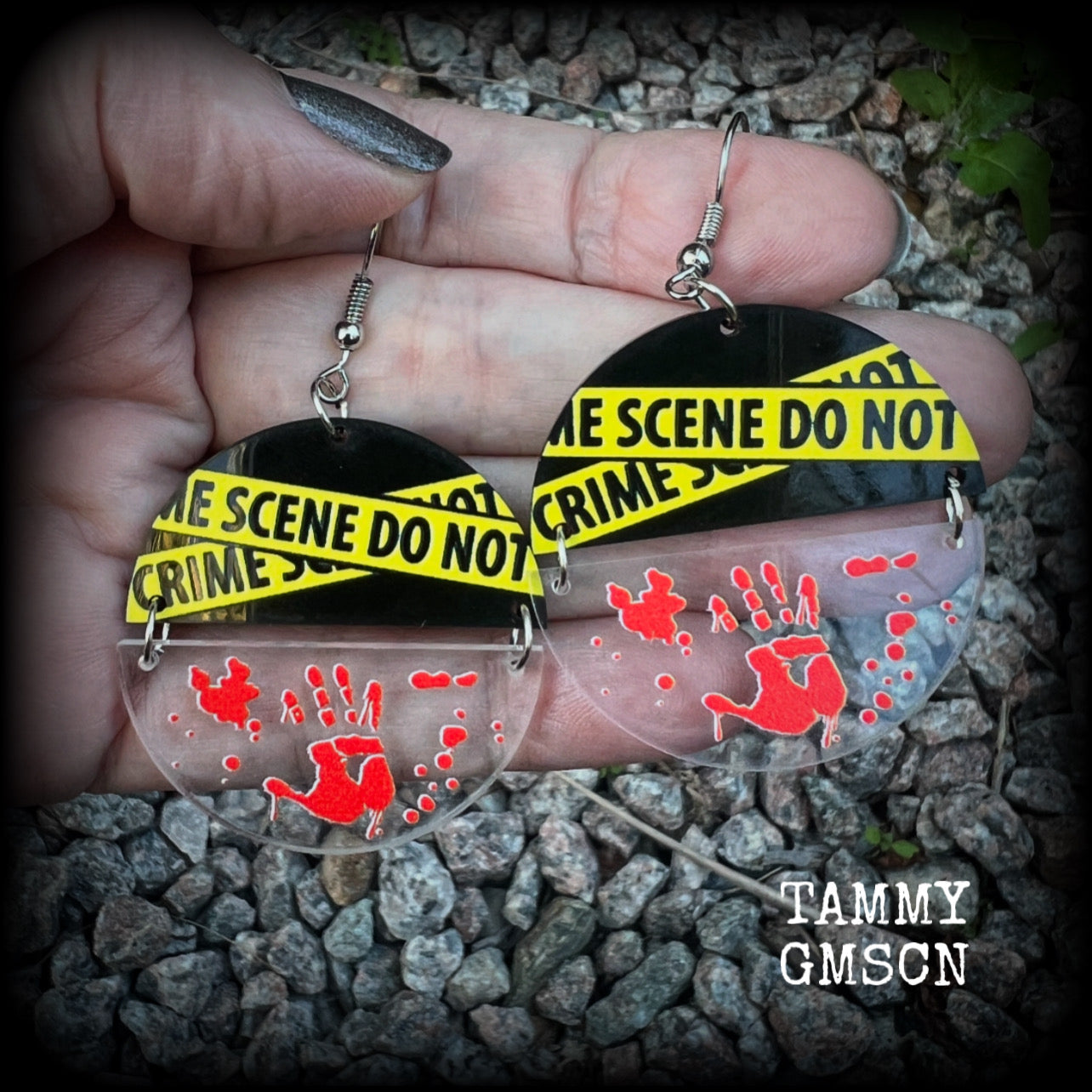 These awesome crime scene inspired earrings feature a bloodied hand print hanging beneath a cautionary crime scene sign, measuring approx 6.5cms from tip to tip and weighing only a few grams each.

This pair has been made with stainless steel french hooks, suitable for pierced ears.