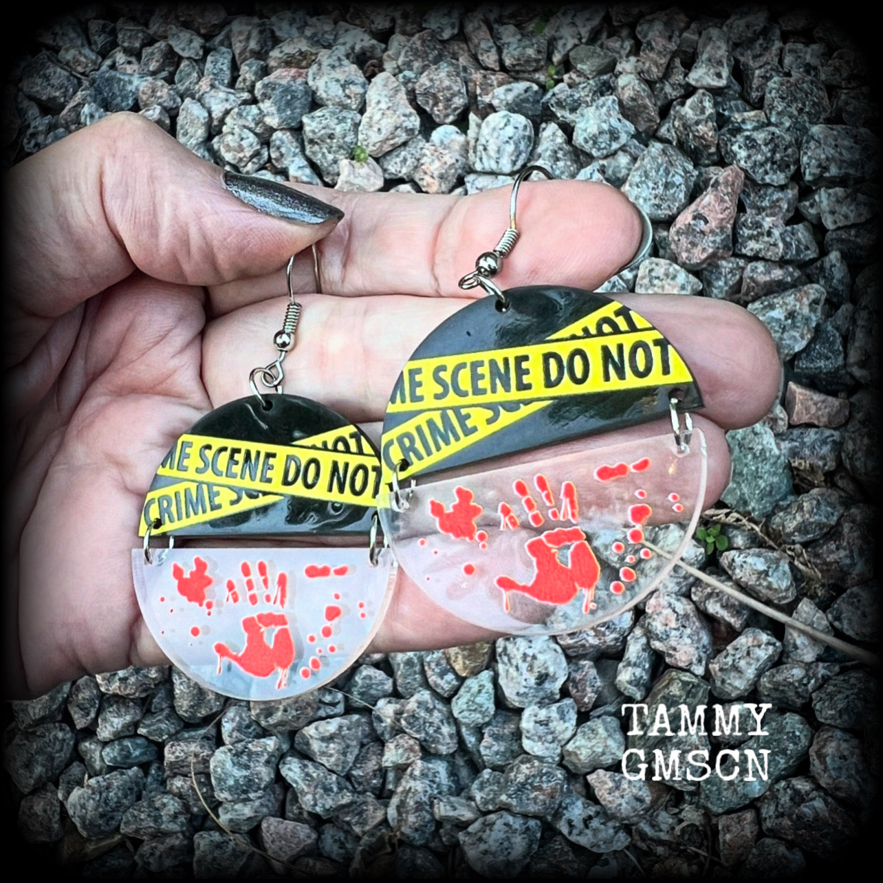 These awesome crime scene inspired earrings feature a bloodied hand print hanging beneath a cautionary crime scene sign, measuring approx 6.5cms from tip to tip and weighing only a few grams each.

This pair has been made with stainless steel french hooks, suitable for pierced ears.