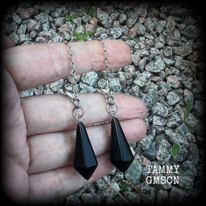 These gorgeous earrings have been made with pitch black obsidian divination pendulums, are nice and light weight at only 5 grams a piece, and are nice and dangly, measuring just over 7cms from tip to tip.

This pair has been made with our super versatile antique silver chain and lobster clasp 4mm option, to be worn through silicone earlets in stretched lobes from 6 gauge (4mm).
