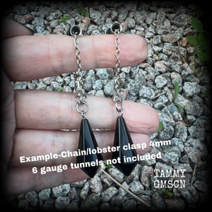 These gorgeous earrings have been made with pitch black obsidian divination pendulums, are nice and light weight at only 5 grams a piece, and are nice and dangly, measuring just over 7cms from tip to tip.

This pair has been made with our super versatile antique silver chain and lobster clasp 4mm option, to be worn through silicone earlets in stretched lobes from 6 gauge (4mm).