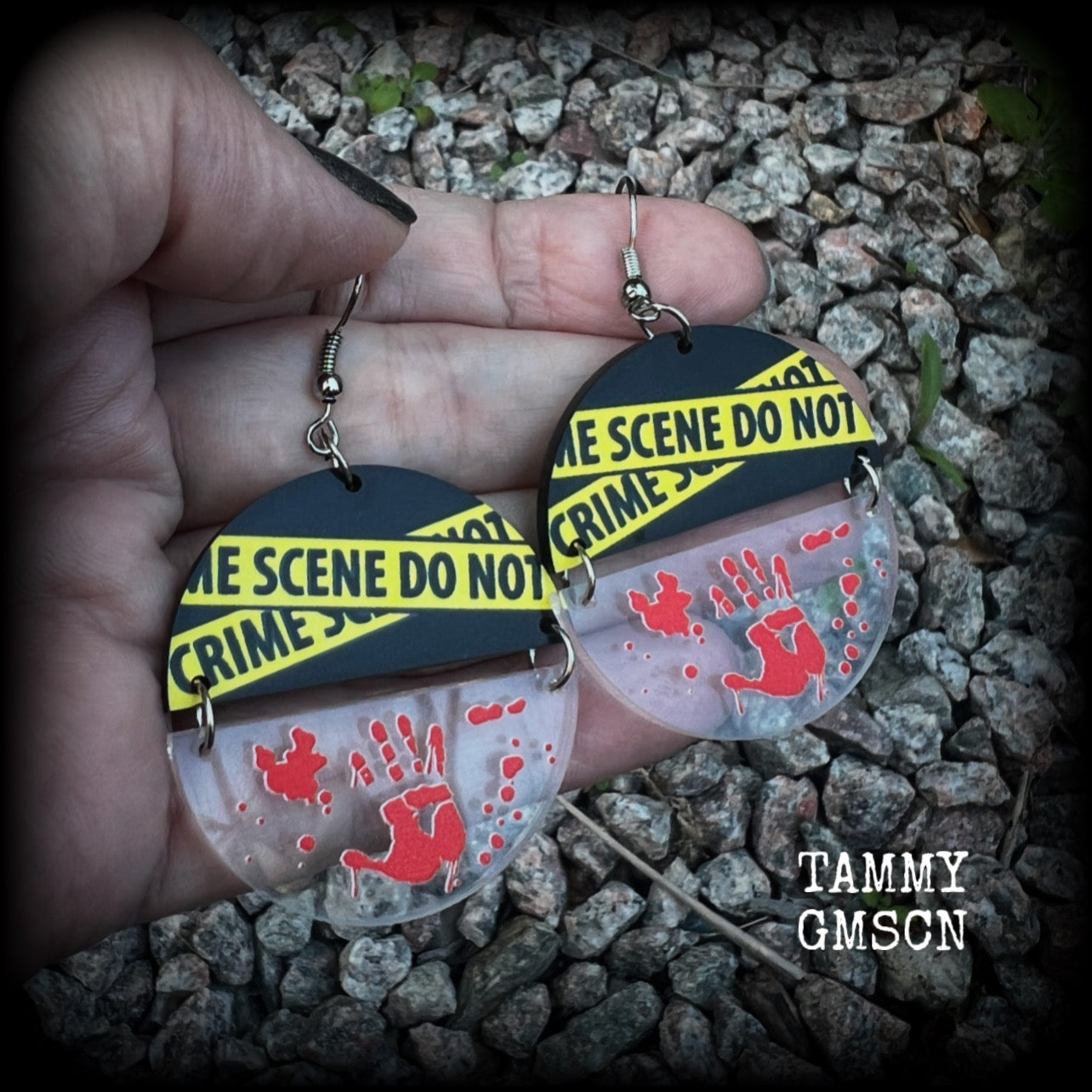 These awesome crime scene inspired earrings feature a bloodied hand print hanging beneath a cautionary crime scene sign, measuring approx 6.5cms from tip to tip and weighing only a few grams each.

This pair has been made with stainless steel french hooks, suitable for pierced ears.