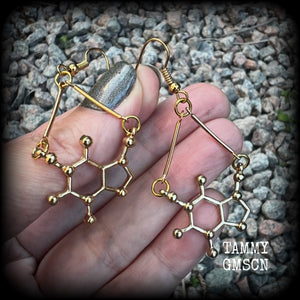 These cute champagne gold earrings feature Theobromine molecules, measuring just on 6cms from tip to tip, and weighing only a few grams each.

This pair have been made with antique gold french hooks, suitable for pierced ears.