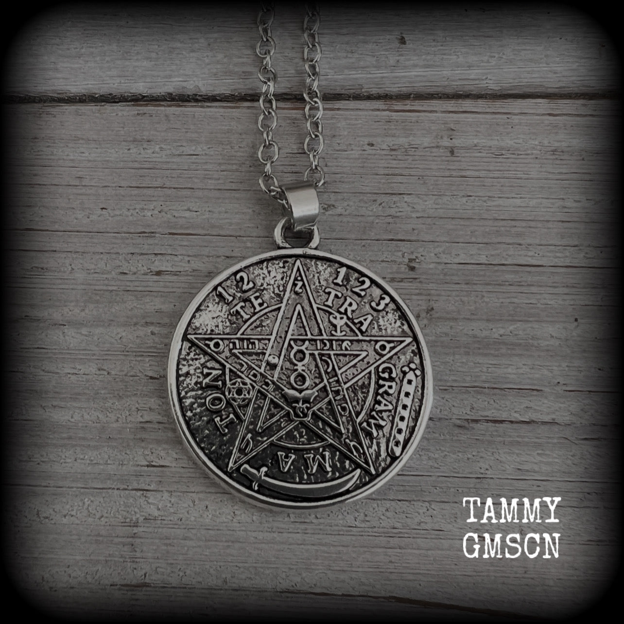 Measuring 16" when laying flat and fastening with an antique silver lobster clasp, this necklace features a two sided tibetan silver Tetragrammaton pendant. 

The pendant on this necklace measures just under 3cms across, and is not too heavy, weighing in at approx 5 grams.