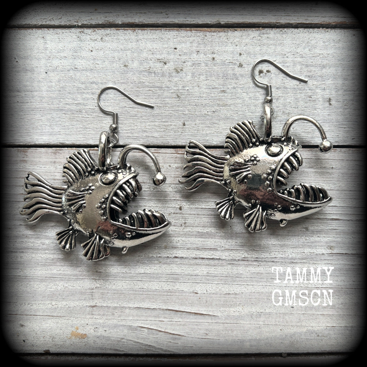 These unique earrings feature big antique silver anglerfishes, weighing 25 grams each and measuring just over 6cms from tip to tip.

This pair have been made on stainless steel french hooks, suitable for pierced ears.