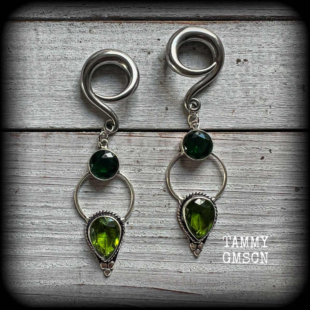 This pair of beautifully dangly earrings features gorgeous green peridot and green quartz gemstones in a boho antique silver setting, weighing approx 11grams a piece and measuring just over 8cms from tip to tip.  This pair have been made on 2 gauge (6mm) surgical steel full curl hooks, to be worn in stretched lobes.