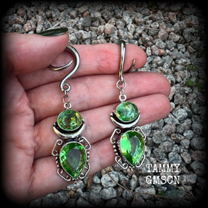 This pair of earrings features gorgeous green quartz and peridot gemstones in a boho antique silver setting, weighing approx 9 grams a piece and measuring approx 8cms from tip to tip.

This pair have been made on 6 gauge (4mm) surgical steel full curl hooks, to be worn in stretched lobes.
