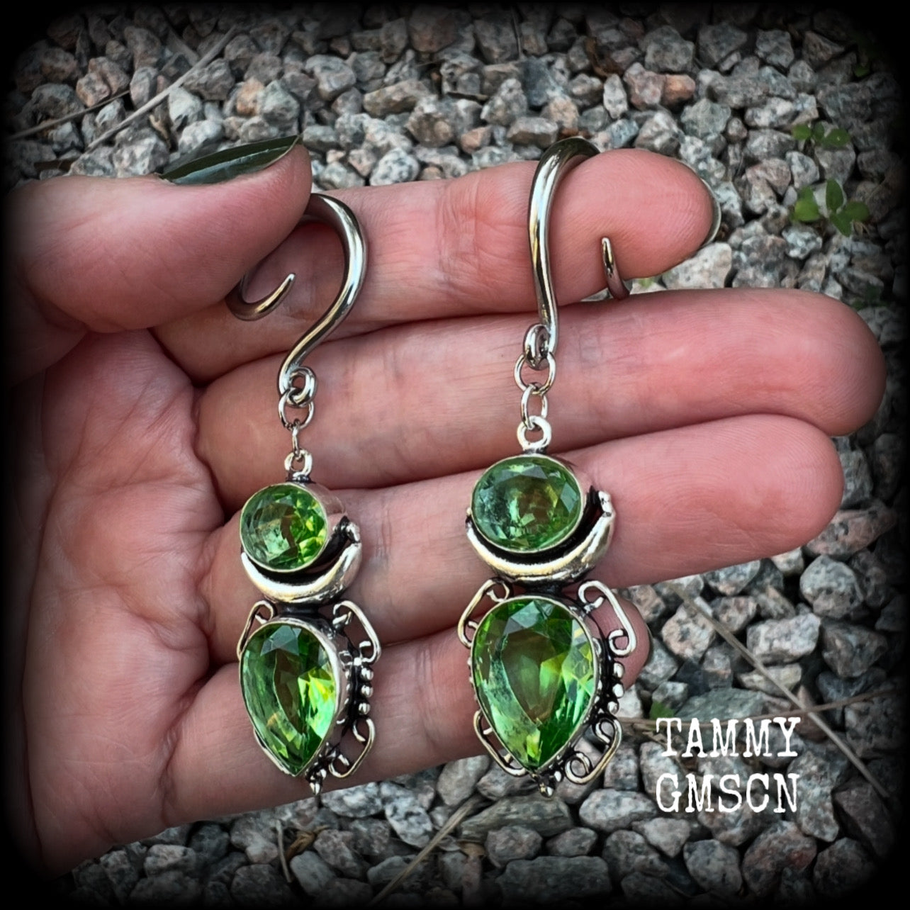 This pair of earrings features gorgeous green quartz and peridot gemstones in a boho antique silver setting, weighing approx 9 grams a piece and measuring approx 8cms from tip to tip.

This pair have been made on 6 gauge (4mm) surgical steel full curl hooks, to be worn in stretched lobes.
