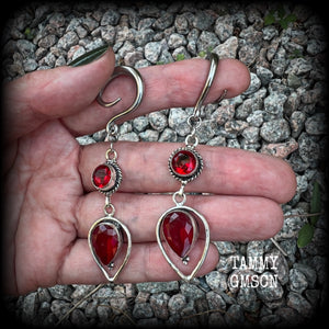 These beautiful gauged earrings feature gorgeous deep red faceted garnet gemstones in an ornate antique silver setting, measuring 7cms from tip to tip, and weighing approx 10 grams each, nice and light weight.

These earrings have been made on 6 gauge (4mm) surgical steel full curl hooks, to be worn in stretched lobes.