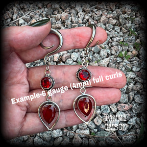 These beautiful gauged earrings feature gorgeous deep red faceted garnet gemstones in an ornate antique silver setting, measuring 7cms from tip to tip, and weighing approx 10 grams each, nice and light weight.

These earrings have been made on 6 gauge (4mm) surgical steel full curl hooks, to be worn in stretched lobes.