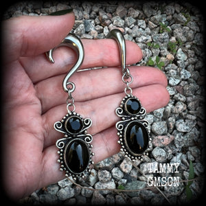 These earrings feature gorgeous pitch black onyx gemstones, lovely and dangly at approx 8cms from tip to tip, and weighing approx 15 grams each.

These earrings have been made on 0 gauge (8mm) surgical steel half curl hooks, to be worn in stretched lobes.