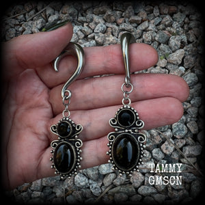 These earrings feature gorgeous pitch black onyx gemstones, lovely and dangly at approx 8cms from tip to tip, and weighing approx 15 grams each.

These earrings have been made on 0 gauge (8mm) surgical steel half curl hooks, to be worn in stretched lobes.