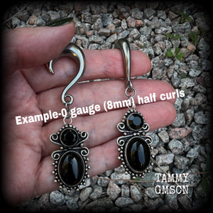 These earrings feature gorgeous pitch black onyx gemstones, lovely and dangly at approx 8cms from tip to tip, and weighing approx 15 grams each.

These earrings have been made on 0 gauge (8mm) surgical steel half curl hooks, to be worn in stretched lobes.