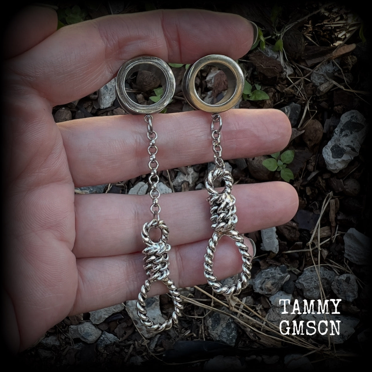 These awesome tunnel dangles feature classic antique silver hangmans nooses dangling from differing lengths of stainless steel chain, weighing only 11 grams each and measuring 9cms from tip to tip.

This pair has made on 5/8" (16mm) gauge standard surgical steel screw fit tunnels.