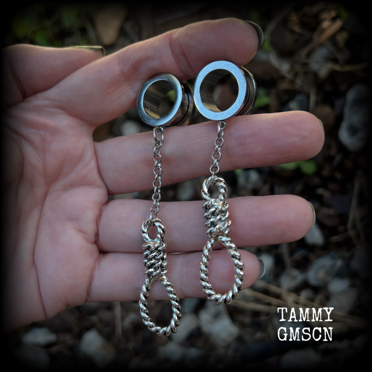 These awesome tunnel dangles feature classic antique silver hangmans nooses dangling from differing lengths of stainless steel chain, weighing only 11 grams each and measuring 9cms from tip to tip.

This pair has made on 5/8" (16mm) gauge standard surgical steel screw fit tunnels.
