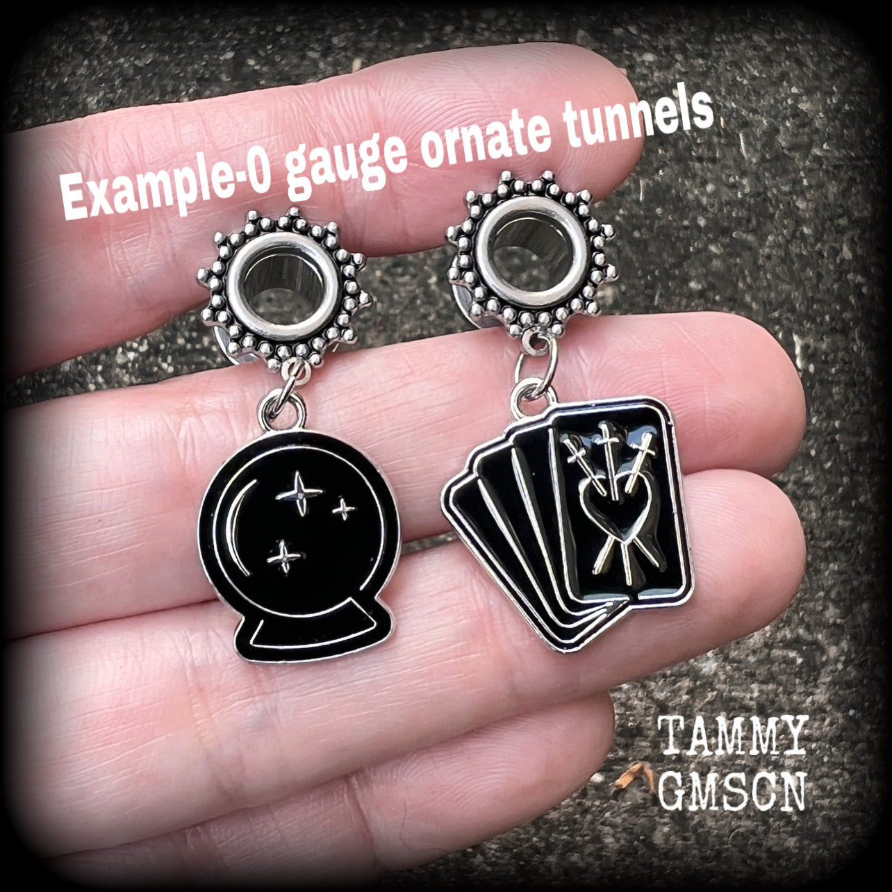 These gorgeous spooky tunnel dangles feature cute black enamel crystal ball and tarot card charms, are nice and lightweight-weighing only 7 grams each and measure 5cms from tip to tip.

This pair have been made on 5/8" (16mm) gauge ornate surgical steel screw fit tunnels.