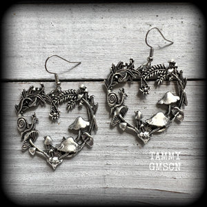 These awesome antique silver forest punk earrings are gorgeous!! 
Featuring a heart of ferns with snails, mushrooms and spiders, these earrings weigh approx 8 grams each, and measure in at just under 6cms from tip to tip.

This pair have been made on stainless steel french hooks, suitable for pierced ears.
