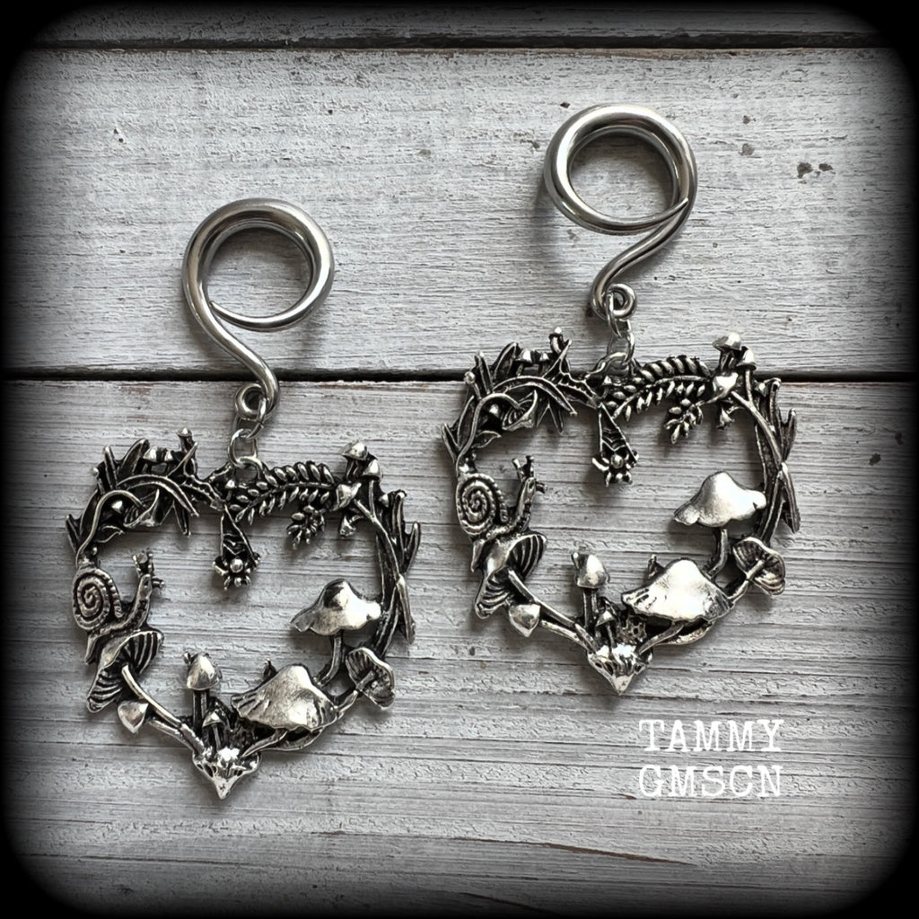 These awesome antique silver forest punk earrings are gorgeous!! 
Featuring a heart of ferns with snails, mushrooms and spiders, these earrings weigh approx 11 grams each, and measure in at just over 7cms from tip to tip.

This pair has been made on 6 gauge (4mm) gauge surgical steel full curls, to be worn in stretched lobes.