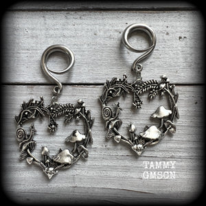 These awesome antique silver forest punk earrings are gorgeous!! 
Featuring a heart of ferns with snails, mushrooms and spiders, these earrings weigh approx 11 grams each, and measure in at just over 7cms from tip to tip.

This pair has been made on 6 gauge (4mm) gauge surgical steel full curls, to be worn in stretched lobes.