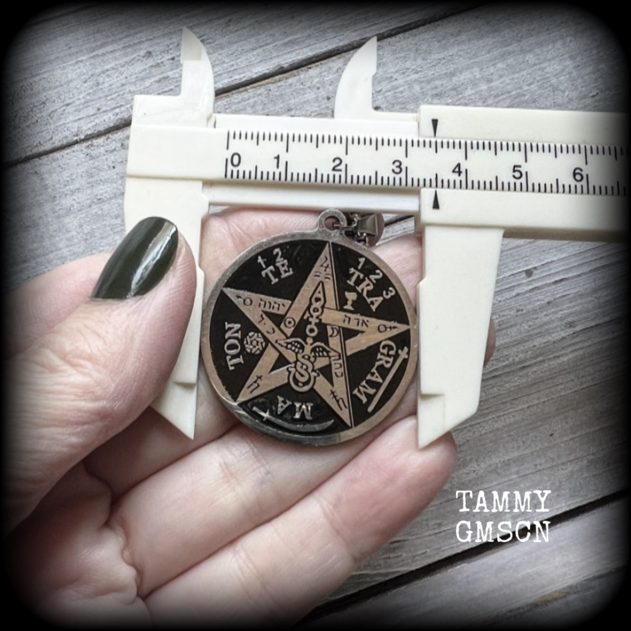 Measuring 16" when laying flat and fastening with an antique silver lobster clasp, this necklace features a stainless steel silver and black Tetragrammaton pendant.

The pendant on this necklace measures approx 3.5cms across, and is not too heavy, weighing in at approx 5 grams.