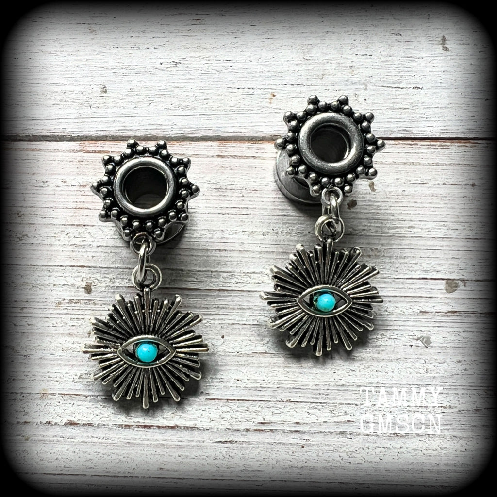 These stunning tunnel earrings feature gorgeous blue turquoise and antique silver all seeing eye charms, are nice and lightweight, weighing approx 7 grams each, measuring 3cms from tip to tip.

This pair has been made with 2 gauge (6mm) ornate surgical steel screw fit tunnels-suitable for stretched lobes.