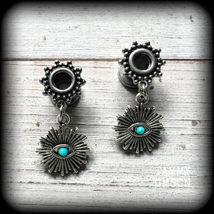 These stunning tunnel earrings feature gorgeous blue turquoise and antique silver all seeing eye charms, are nice and lightweight, weighing approx 7 grams each, measuring 3cms from tip to tip.

This pair has been made with 2 gauge (6mm) ornate surgical steel screw fit tunnels-suitable for stretched lobes.
