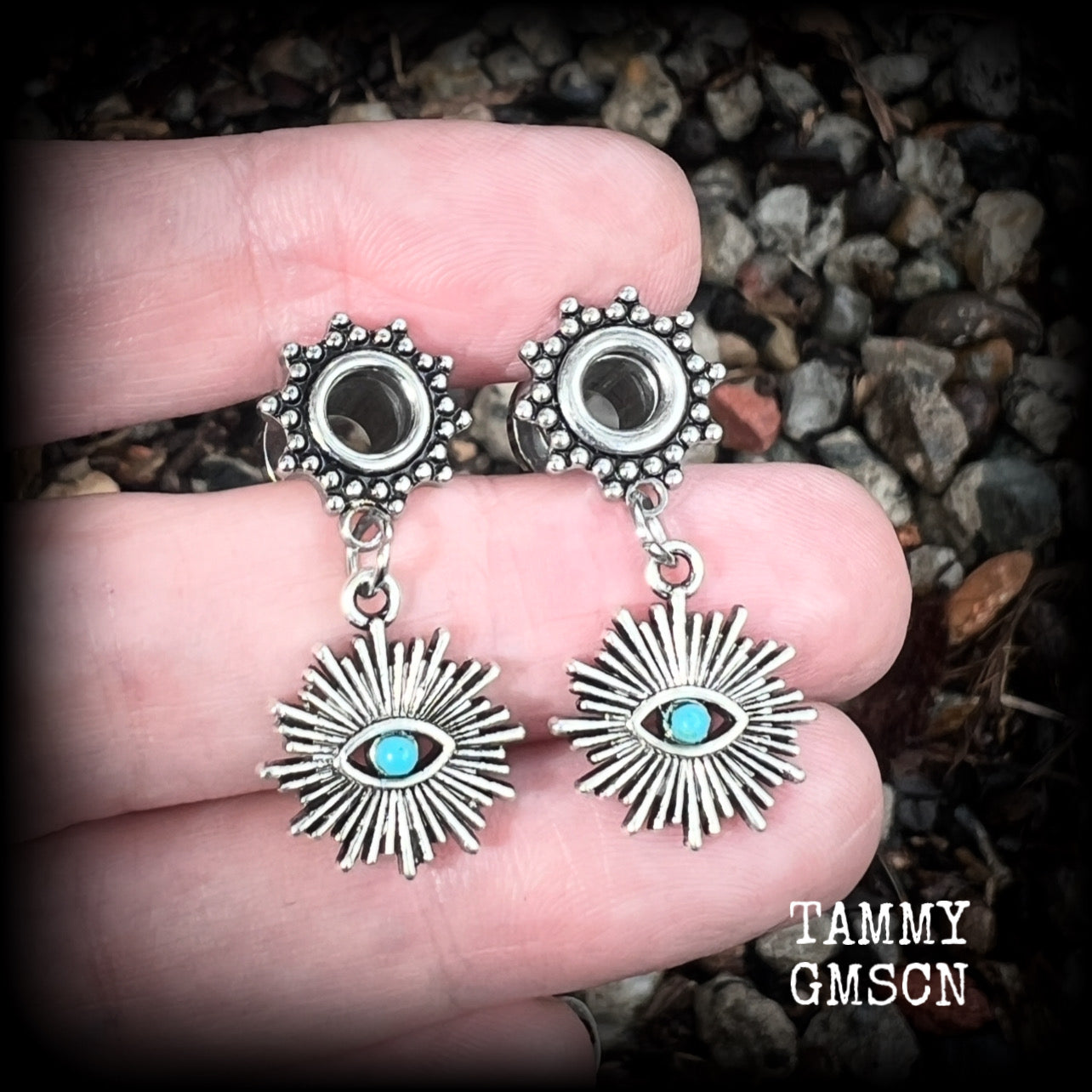 These stunning tunnel earrings feature gorgeous blue turquoise and antique silver all seeing eye charms, are nice and lightweight, weighing approx 7 grams each, measuring 3cms from tip to tip.

This pair has been made with 2 gauge (6mm) ornate surgical steel screw fit tunnels-suitable for stretched lobes.