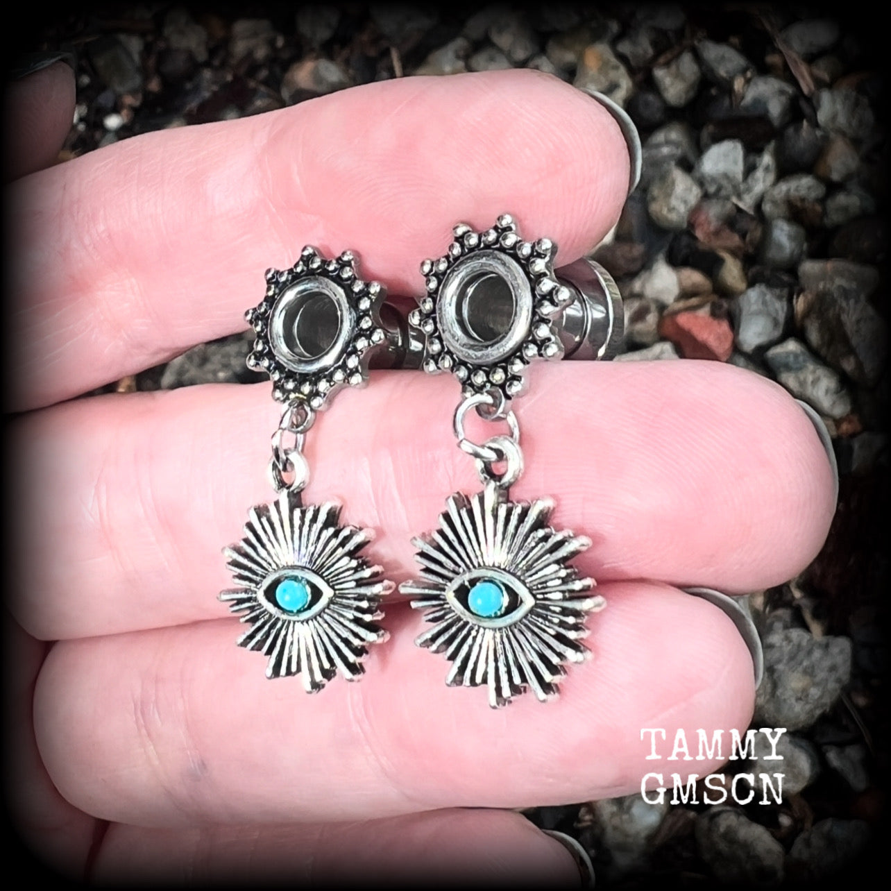 These stunning tunnel earrings feature gorgeous blue turquoise and antique silver all seeing eye charms, are nice and lightweight, weighing approx 7 grams each, measuring 3cms from tip to tip.

This pair has been made with 2 gauge (6mm) ornate surgical steel screw fit tunnels-suitable for stretched lobes.