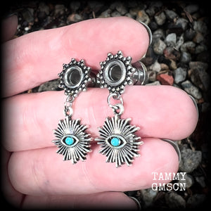 These stunning tunnel earrings feature gorgeous blue turquoise and antique silver all seeing eye charms, are nice and lightweight, weighing approx 7 grams each, measuring 3cms from tip to tip.

This pair has been made with 2 gauge (6mm) ornate surgical steel screw fit tunnels-suitable for stretched lobes.