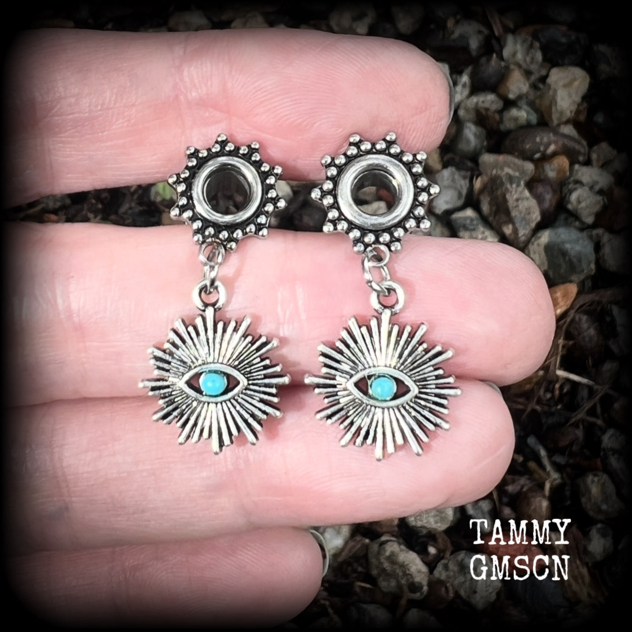 These stunning tunnel earrings feature gorgeous blue turquoise and antique silver all seeing eye charms, are nice and lightweight, weighing approx 7 grams each, measuring 3cms from tip to tip.

This pair has been made with 2 gauge (6mm) ornate surgical steel screw fit tunnels-suitable for stretched lobes.
