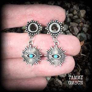 These stunning tunnel earrings feature gorgeous blue turquoise and antique silver all seeing eye charms, are nice and lightweight, weighing approx 7 grams each, measuring 3cms from tip to tip.

This pair has been made with 2 gauge (6mm) ornate surgical steel screw fit tunnels-suitable for stretched lobes.