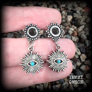 These stunning tunnel earrings feature gorgeous blue turquoise and antique silver all seeing eye charms, are nice and lightweight, weighing approx 7 grams each, measuring 3cms from tip to tip.

This pair has been made with 2 gauge (6mm) ornate surgical steel screw fit tunnels-suitable for stretched lobes.