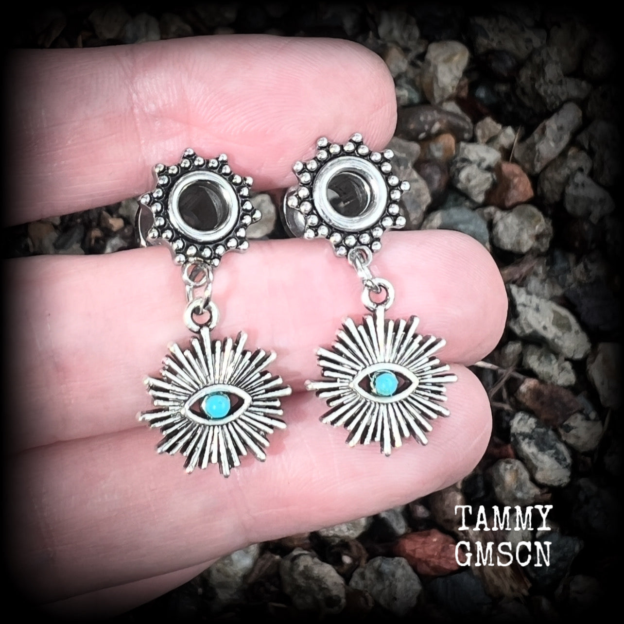 These stunning tunnel earrings feature gorgeous blue turquoise and antique silver all seeing eye charms, are nice and lightweight, weighing approx 7 grams each, measuring 3cms from tip to tip.

This pair has been made with 2 gauge (6mm) ornate surgical steel screw fit tunnels-suitable for stretched lobes.