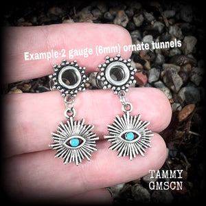 These stunning tunnel earrings feature gorgeous blue turquoise and antique silver all seeing eye charms, are nice and lightweight, weighing approx 7 grams each, measuring 3cms from tip to tip.

This pair has been made with 2 gauge (6mm) ornate surgical steel screw fit tunnels-suitable for stretched lobes.
