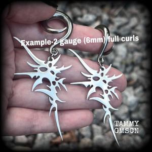 These awesome punk rock earrings feature stainless steel cybersigils, weighing approx 9 grams a piece, and nice and dangly on 8cms from tip to tip.  This pair has been made on 2 gauge (6mm) surgical steel full curl hooks, suitable for stretched lobes.